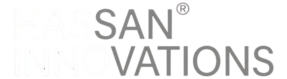 A minimalist, two-line logo on a solid black background. The top line reads 'HASSAN' and the bottom line reads 'INNOVATIONS,' both in a clean, all-caps geometric sans-serif font. The text is left-aligned, featuring a high-contrast style where the first four letters of each word are bright white and the remaining letters are a muted medium grey. A small registered trademark symbol (®) appears at the top right.